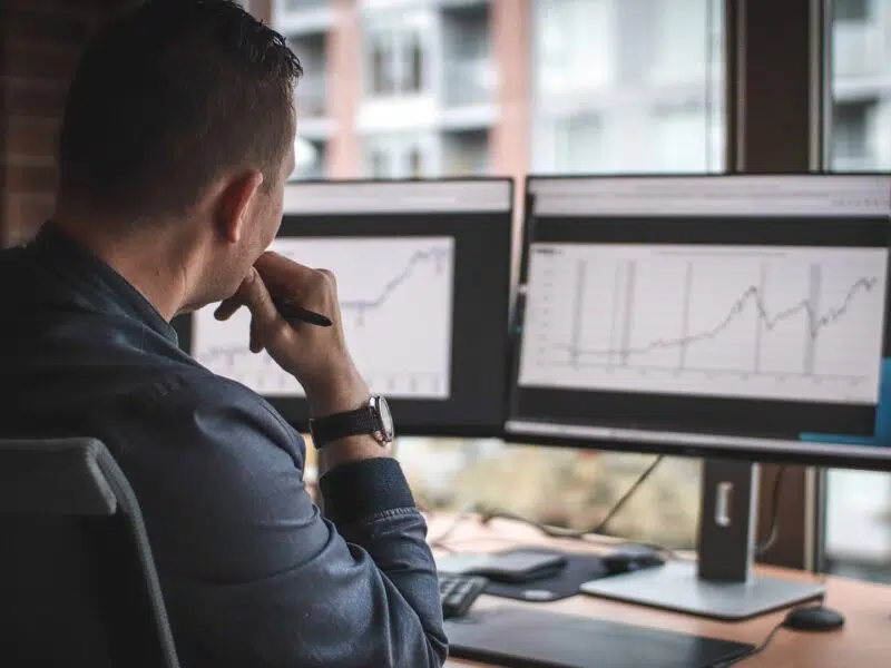 manager using 2 screens to analyze data