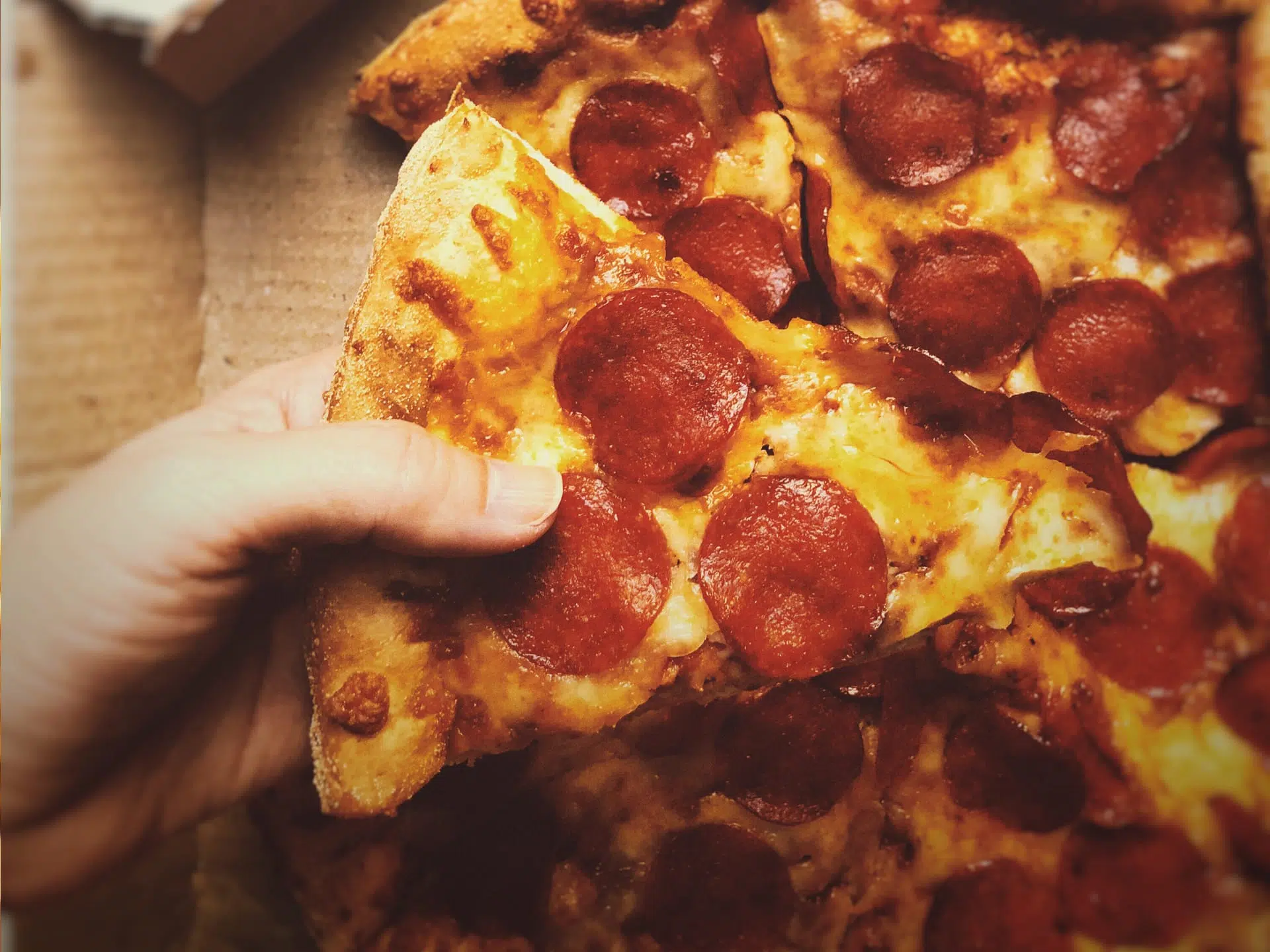 customer eating a piece of pizza