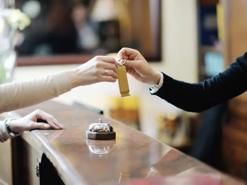 hotel worker giving customer a room key