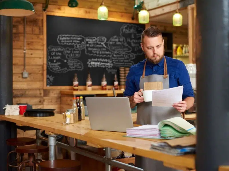 manager looking at resumes for hiring
