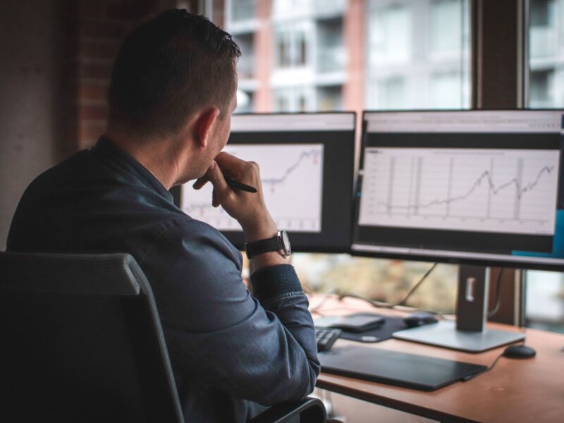 analyzing financial data on a dual screen
