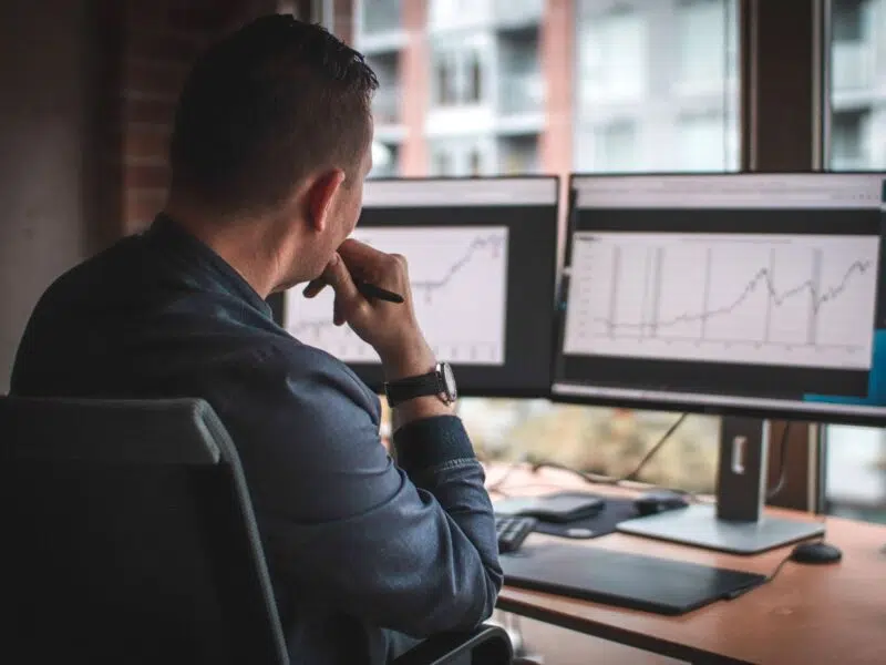 analyzing financial data on a dual screen